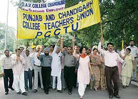 College teachers marching to Punjab Bhavan in Chandigarh on Monday.