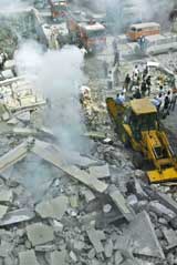 Rescue workers search through the rubble of a destroyed building following an Israeli air strike on a village in Lebanon on Monday