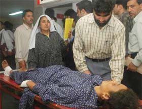 A woman injured in a grenade blast at Handwara being taken to a hospital in Srinagar