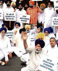 Shiromani Akali Dal chief Parkash Singh Badal, party MPs, MLAs and gurdwara leaders sit in dharna near Mahatma Gandhis statue against the Central move to raise the MSP for paddy and cotton by just Rs 10 a quintal, calling it a cruel joke on farmers, at Parliament House in New Delhi on Tuesday.