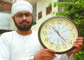 Jaswinder Singh Namdhari shows his clock with times of 13 countries
