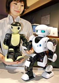 Japan's radio-controlled model maker Kyosho unveils two types of humanoid robots Manoi AT01 and Manoi PF01, which have 17 actuators and are controlled by wireless or with programing, at the company's showroom in Tokyo on Wednesday.