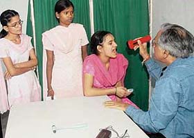 A patient is examined during a free medical, dental and eye check-up camp at Sood Bhavan, Sector 44, Chandigarh