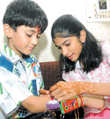 A sister tying rakhi on her brothers wrist on the occasion of Raksha Bandhan in the Capital