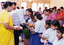 Physically challenged students of Vocational Rehabilitation Centre for the Blind tie rakhis on the wrist of a social activist in Ludhiana on Wednesday.