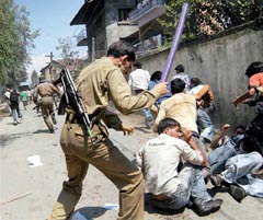 The police chases college students protesting against the killing of Ghulam Mohammad Sheikh, a final-year student of Amar Singh College, Wazirbagh, by the CRPF, in Srinagar 