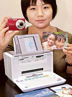 Japan's Casio Computer employee displays an all-in-one printer "PCP-120"