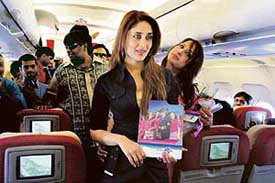 Actress Kareena Kapoor (centre) poses with a brochure of the Flying Cats Air Hostess Aviation School in an aircraft en route to Chandigarh on Thursday. 