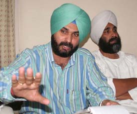 BJP MP from Amritsar Navjot Singh Sidhu addresses media persons at a press conference in Jalandhar on Friday.