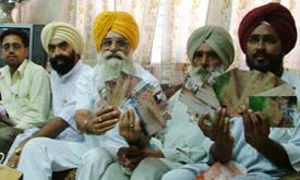 Former Akali MLA Jagdish Singh Garcha, accompanied by sarpanches, shows photographs of the work being done in his area, despite stay orders from the Punjab and Haryana High Court