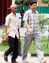 Amrit Lal, who has been booked by the police, leaves the court after hearing in Mohali
