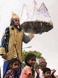 Devotees take part in a shobha yatra organised by the Kendria Sanatan Dharam Mandir Kalyan Samiti for Janamasthami in Mohali