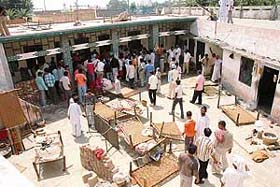 People gather at the house of one of the persons picked up by the Punjab police after ransacking the house on Saturday at Lalru