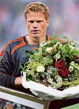 Munichs goalkeeper Oliver Kahn carries a bouquet that he received for his 500th Bundesliga appearance ahead of the opening match of the Bundesliga season against Dortmund in Munich.
