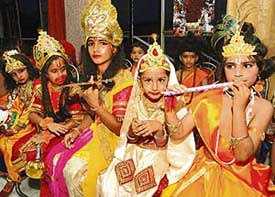 Children dressed as Lord Krishna and his consort Radha wait for their turn during a fancy dress competition at Hare Krishna Dham, Sector 36-B, Chandigarh