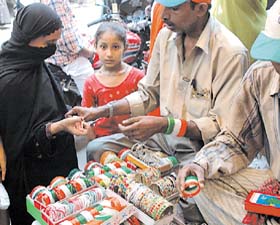 A woman buying a tricoloured bangle on the eve of the Independence Day in Old Delhi