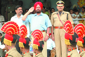 Punjab Minister for Cooperation and NRIs Amarjit Singh Samra accepts a guard of honour during an Independence Day function at Guru Gobind Singh Stadium in Jalandhar on Tuesday.