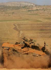 An Israeli tank crosses the Israel-Lebanon border from South Lebanon