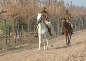 BSF jawans patrol the fenced India-Pakistan border near Wagah. 