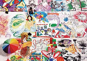 Artists paint on a canvas spread out in Sector 17 in Chandigarh