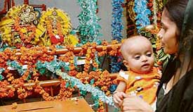 A devotee rocks the cradle of Lord Krishna at Sri Govind Dham Temple, Sector 12, Panchkula, on Wednesday