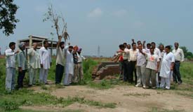 Villagers raise slogans at a disputed site in Noorwala village on Wednesday following communal tension