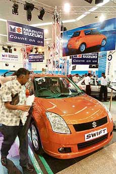 A Sri Lankan national walks past a car displayed at an exhibition of Indian motor vehicles in Colombo on Friday.
