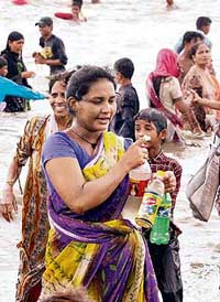 Mumbaikars throng the Mahim sea beach on Saturday to drink and collect sea water which, locals claim, has turned sweet. 