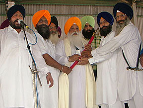 Expelled members of the SAD honour Mr Raghubir Singh, secretary of the SGPC, at a rally organised in Ajnala on Saturday.