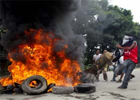 Demonstrators burn tyres against the sudden rise in oil prices in the Nepali capital of Kathmandu