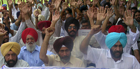 Members of the Sector 76-80 Plot Allotment Sangharsh Committee protest in Mohali on Sunday. 