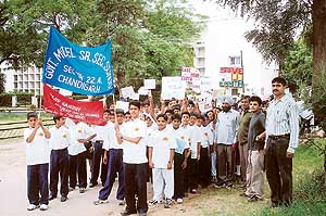 Students of Government Senior Secondary School, Sector 22-A, Chandigarh, take out a rally here to celebrate the Rajiv Gandhi Akshay Urja Divas on Sunday.