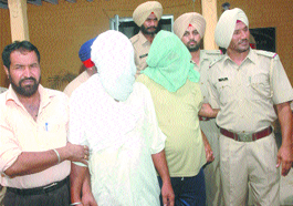 Two alleged inter-district smugglers in police custody in Jalandhar on Monday.
