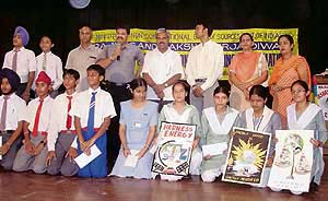 Deputy Commissioner Ashok Kumar Gupta with winners of various district-level competitions at Guru Nanak Bhavan on Monday.