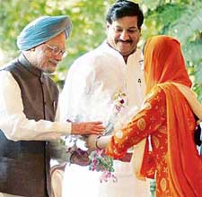Prime Minister Manmohan Singh receives a bouquet from a member of a delegation from Jammu and Kashmir at his residence in New Delhi on Monday