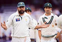 Pakistan captain Inzamam-ul-Haq gestures as his team-mates look on during the fourth day of the fourth Test against England at the Oval in London on Sunday. 