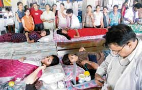 Volunteers donate blood at a blood donation camp GCG-42, Chandigarh, on Wednesday. 