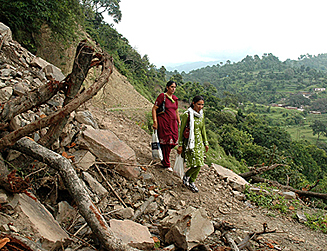 Teachers of a government school in Thandog walk along a path cleared by the villagers after a landslide which had blocked the road in Morni on Thursday. 