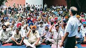 Employees of the PAU protest against the local Audit Department of the Punjab Government on the university campus on Thursday. 