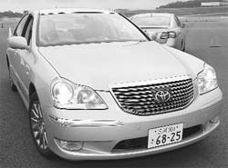 President of Toyota Motor Katsuaki Watanabe (left) drives a car equipped with a newly developed pre-crash safety system using millimetre-wave radar at a test-drive in Oyama on Friday.