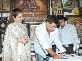 Seema Naquvi, owner of Asman Art Gallery, with film director Madhur Bhandarkar at the launch of the gallery website at Mayur Vihar in the Capital on Friday.