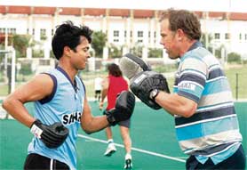 Indian hockey captain Dilip Tirkey (left) with the teams Australian trainer Derek Knox.