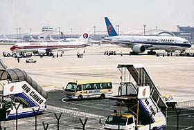 A China Southern Airlines Boeing 777 (right) sits with a damaged wing after clipping the rear of a China Eastern Airlines Airbus 320 while taxiing on the tarmac at Beijing International Airport on Sunday.
