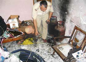 A police officer examines the room in a house in Sector 23, Chandigarh, where a woman sustained burn injuries