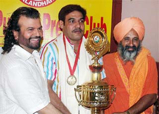 Arjuna Awardee wrestler Randhir Singh (centre) being felicitated by renowned environmentalist Baba Balbir Singh Seechewal and Sufi singer Hans Raj Hans at the Punjab Press Club in Jalandhar on Sunday.