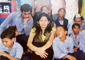 Nancy Sharma, a 17 year old student of 12th grade from Toronto, Canada, with the children of the Nirdosh school in Ludhiana