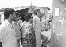 Men of Rasulpur village in Yamunanagar reading a resolution of the panchayat regarding fines being imposed on the unauthorised sale and consumption of liquor
