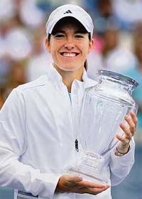 Justine Henin-Hardenne of Belgium holds the trophy after winning the Pilot Pen tennis tournament in New Haven, Connecticut