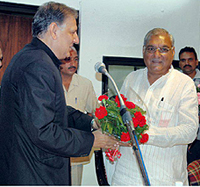 Chief Minister Bhupinder Singh Hooda greets Bhaskar Chatterjee shortly after his swearing in as Chairman of the Haryana Electricity Regulatory Commission in Chandigarh on Monday.