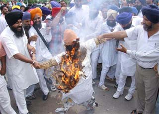 Akali Dal (Badal) activists burn an effigy of the Punjab Chief Minister in Jalandhar on Monday.
